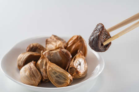 The black garlic is finished by cooking fresh and delicious garlic.の写真素材