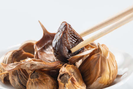 The black garlic is finished by cooking fresh and delicious garlic.の写真素材