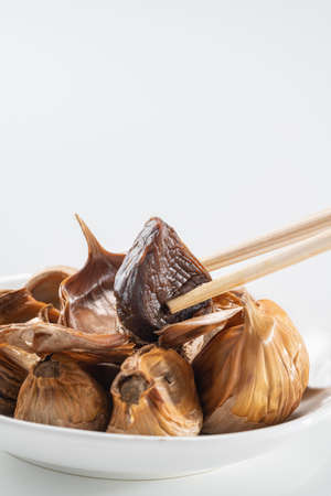 The black garlic is finished by cooking fresh and delicious garlic.の写真素材