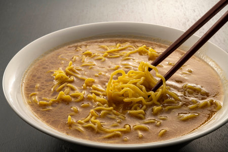 chinese noodle soup with chopsticks on wooden table background.Japanese noodles and soup ramen