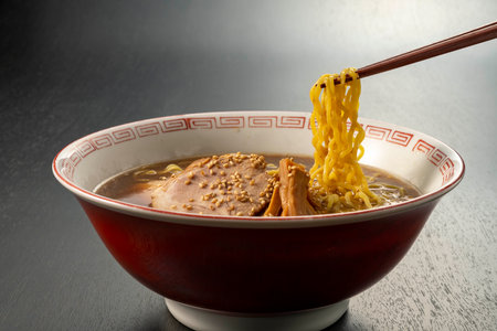japanese ramen noodle soup with chopsticks on black backgroundの写真素材