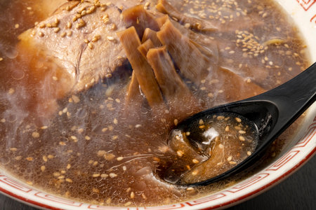 Chinese soup with beef in a bowl on a black background close-upの写真素材