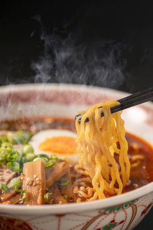 japanese ramen noodle soup with chopsticks on black backgroundの写真素材