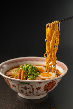miso ramen noodle with chopsticks on black backgroundの写真素材