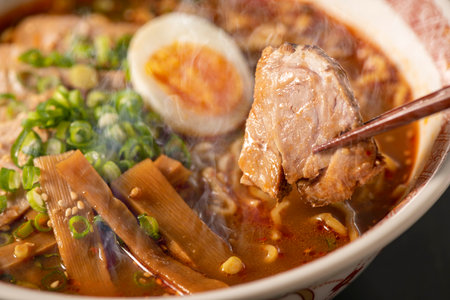 japanese noodle soup with pork and egg on black backgroundの写真素材