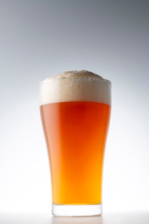 Glass of beer with foam on a white background. Studio shot.の写真素材