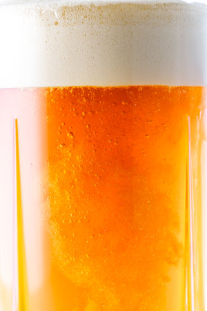 glass of beer with foam on a white background. close-upの写真素材