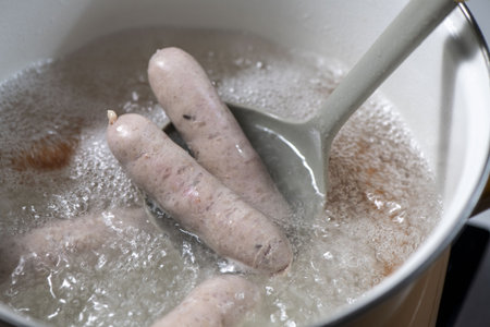 Boiling sausages in a pot, closeup of photoの写真素材