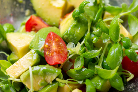 Avocado salad with arugula and cherry tomatoes, closeupの写真素材