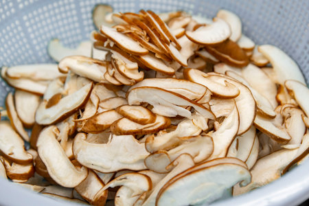 dried mushrooms in a bowl on a wooden table close-upの写真素材