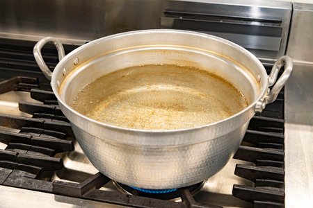 pot with boiling water on the gas stove in the kitchenの写真素材