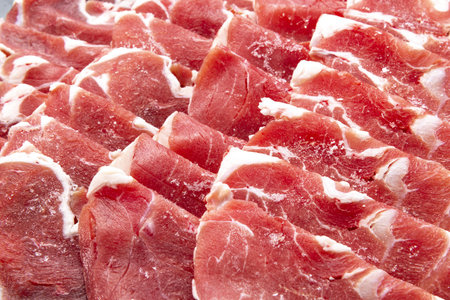 slices of bacon on a cutting board, close-upの写真素材