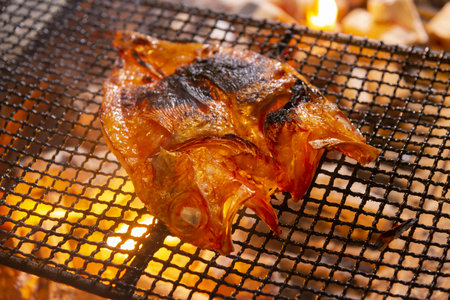 Fried fish on the grill in the restaurant, close-upの写真素材