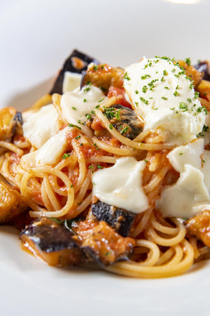 Spaghetti with mussels and mozzarella on a white plateの写真素材