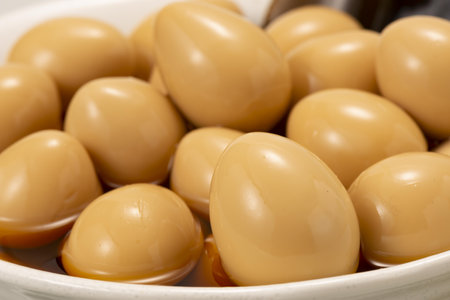 close up of brown eggs in a bowl on a wooden tableの写真素材
