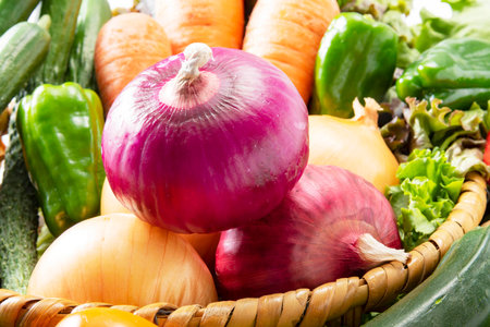 Fresh vegetables in a basket on a wooden table. Shallow dof.の写真素材