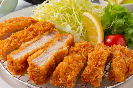 Japanese food, deep fried pork cutlet served with fresh vegetable saladの写真素材