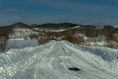 Winter road in the mountains. Winter landscape with snowdrifts.の写真素材