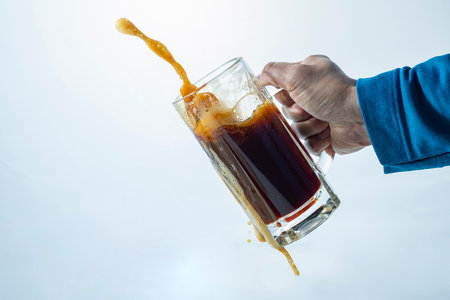 close up of a man's hand holding a glass