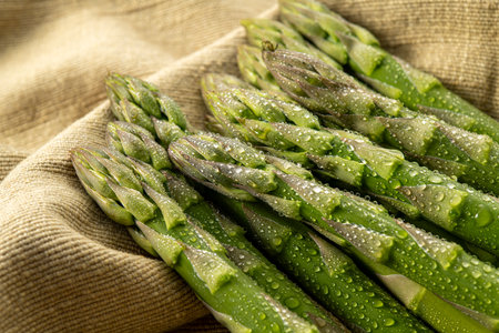 Bunch of fresh asparagus on sackcloth, closeupの写真素材