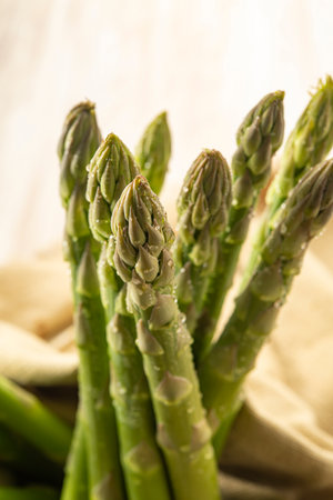 Fresh green asparagus on a rustic wooden table, close upの写真素材