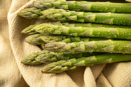 Fresh green asparagus with water drops on a linen napkinの写真素材