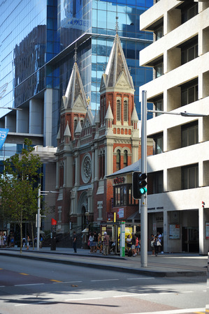 Skyscraper and church in city setting with traffic in Perthのeditorial素材