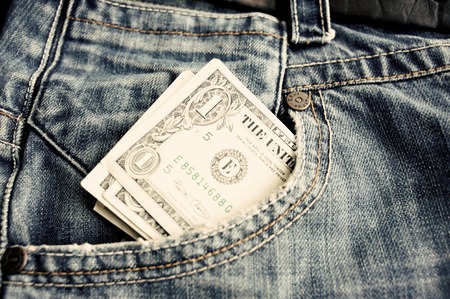 One dollar bill in a pocket of blue jeans. Close up.の写真素材