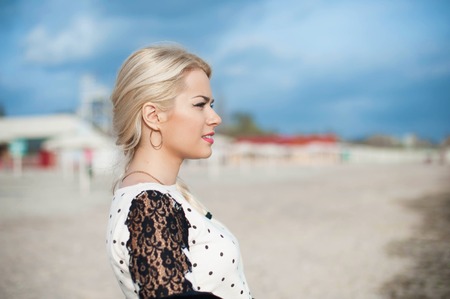 Portrait of a beautiful young woman with blond hair in nature.の写真素材