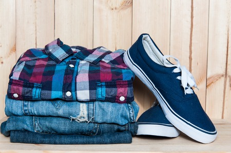 Clothes and shoes on a wooden background close up