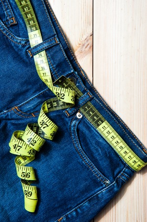 Jeans and a measuring tape.Concept of loosing weight.の写真素材