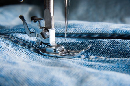 Part of sewing machine and jeans cloth closeupの写真素材