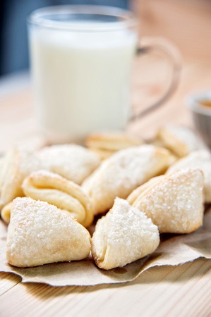 Fresh baked cheese cookies with cup of milk background, closeupの写真素材
