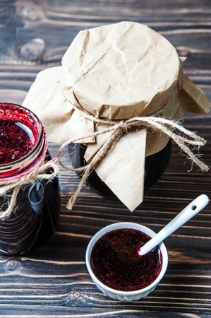 Jar and bowls of blueberry jam on wooden backgroundの写真素材