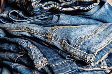 stack of blue jeans closeup, fashion backgroundの写真素材