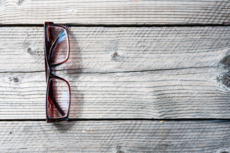 Soft focus wooden work table with glasses with copy spaseの写真素材