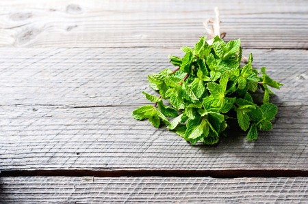 Fresh mint on rustic wooden backgroundの写真素材
