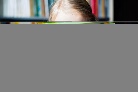 Beautiful happy smiling student with pile of books