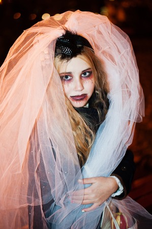 Girl teenager in the image of a dead bride zombie on halloween portraitの写真素材