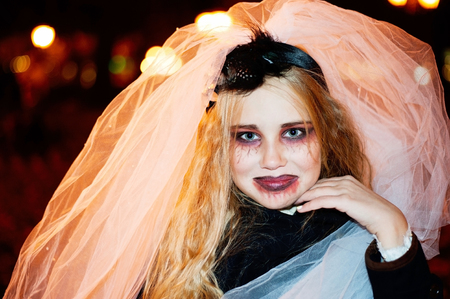 Girl teenager in the image of a dead bride zombie on halloween closeup portraitの写真素材