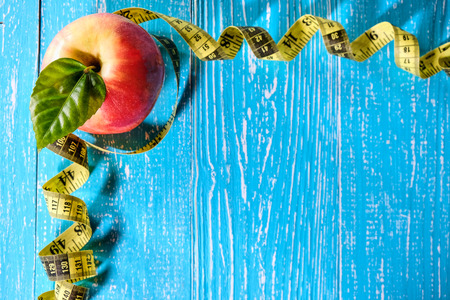 Apple with a measuring tape around it, top view, copyspace.の写真素材