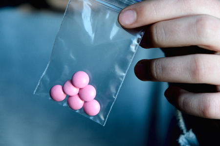 A hand holding a pack pills. Prescripted medication: painkillers, light narcotics, antibiotics. Pharmaceutical modern scienceの写真素材