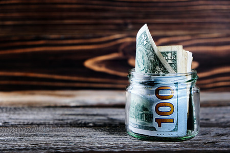 saving money in jar with American dollors , cashの写真素材