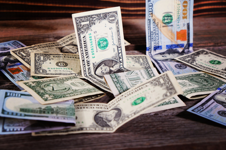 Dollar bills on the wooden table. Financial background.