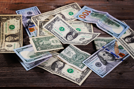 Dollar bills on the wooden table. Financial background. Closeup.の写真素材
