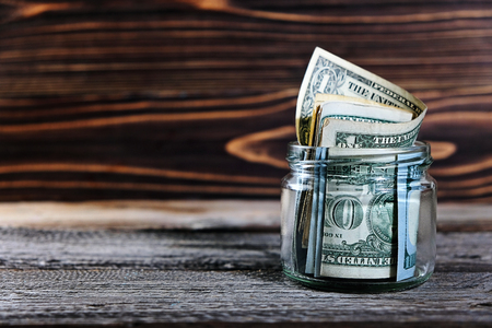 saving money in jar with American dollars , cashの写真素材