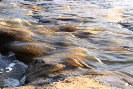 Bright flowing water in creekの写真素材