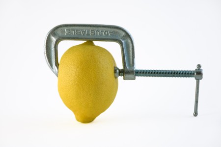 Adjustable vice squeezing a lemonの写真素材