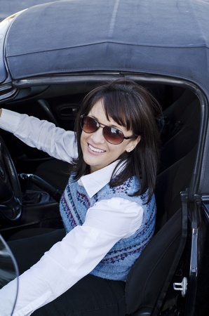 Looking down at a pretty woman getting out of her carの写真素材