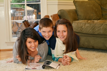 Brother piles on top of his sistersの写真素材